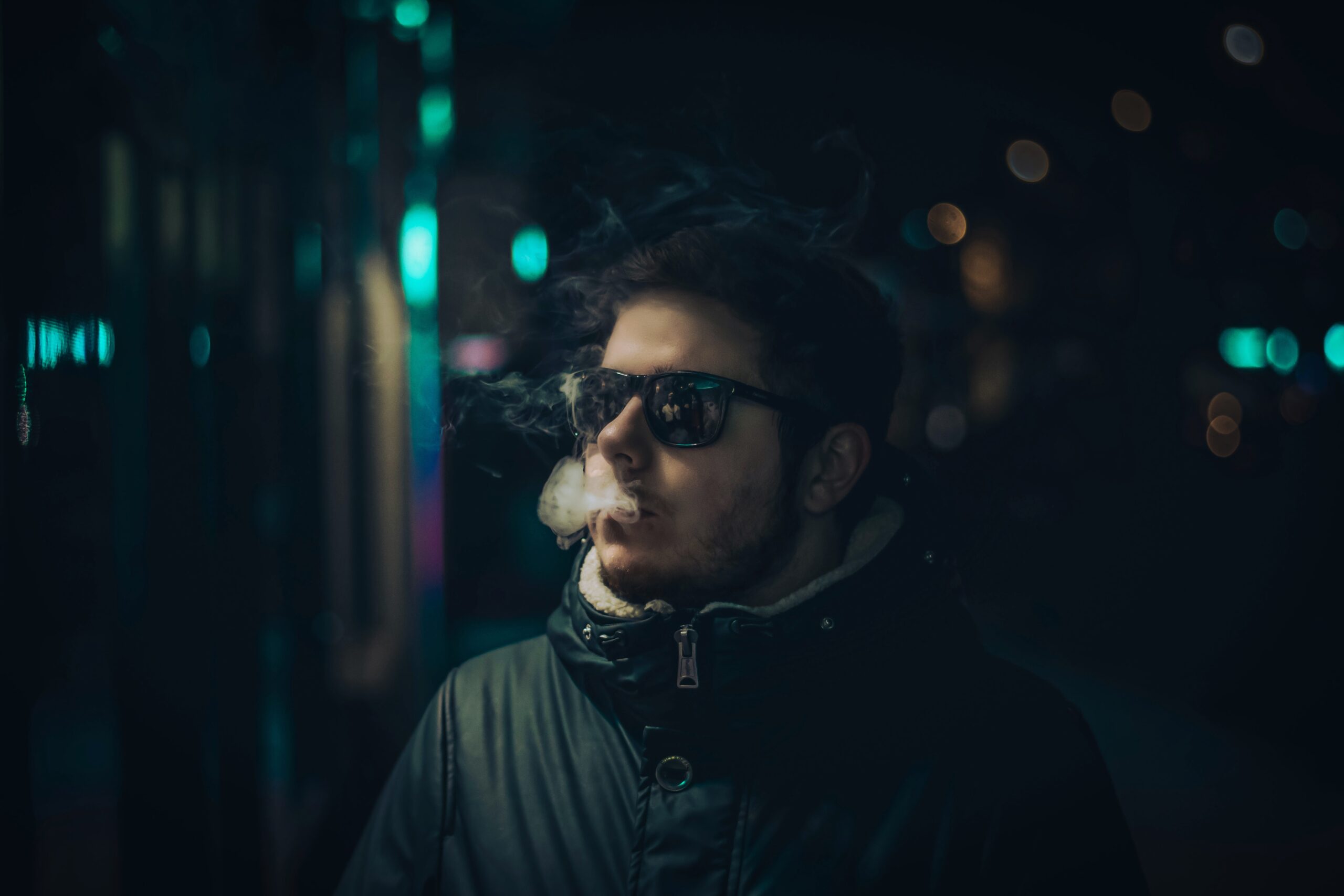 man smoking wearing black framed sunglasses