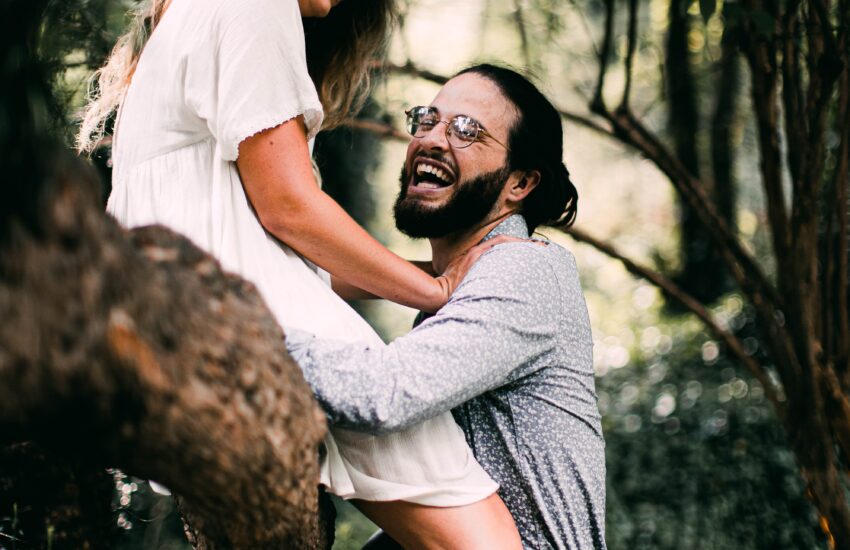 man in white t-shirt hugging woman in white t-shirt