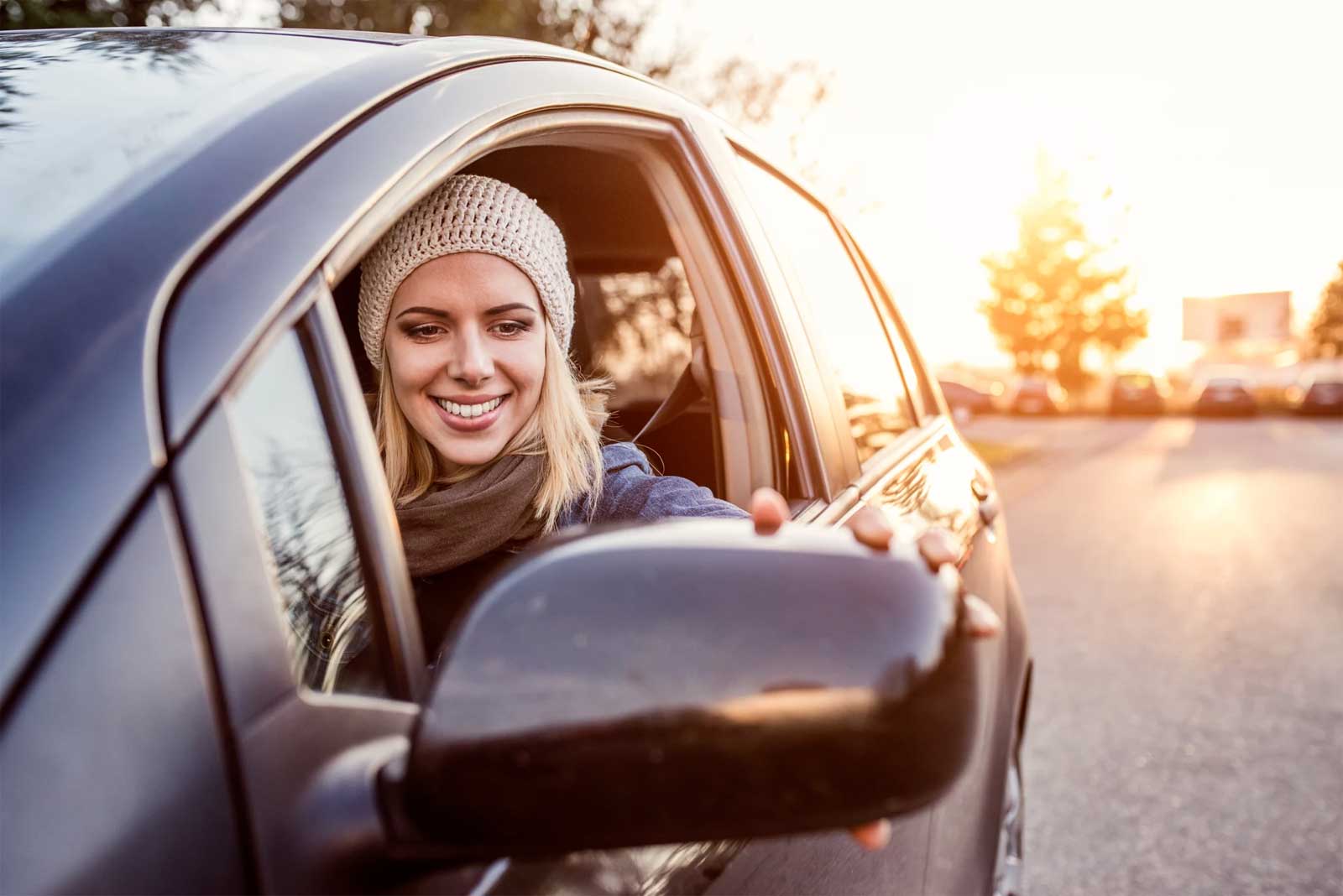Beautiful young blond woman driving a car